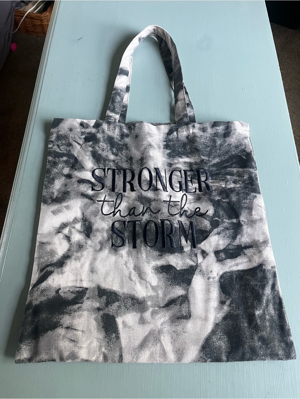 Medium tote bag black and white tie die “Strong than the Storm” on the bag